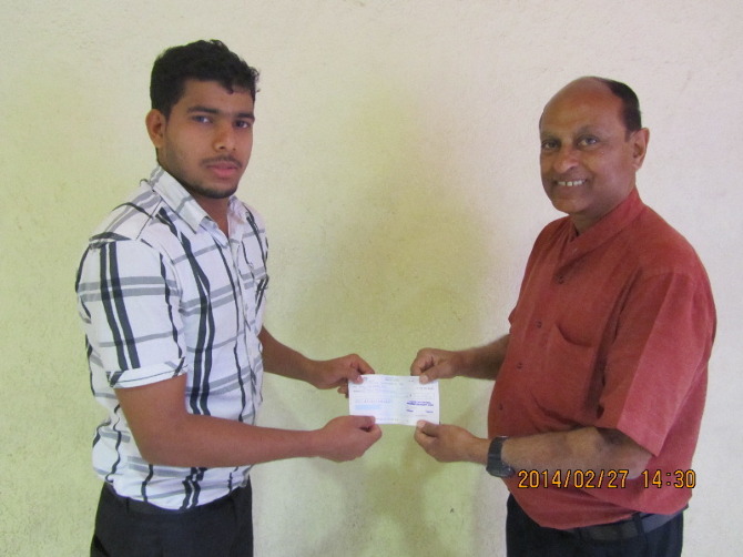 CEES Chairperson handing a cheque to Mr.Nishad Ali son of Mr.Hamza  a farm labourer  to assist their family to build their house in Chemmalaserry village in Mallappuram district  Kerala